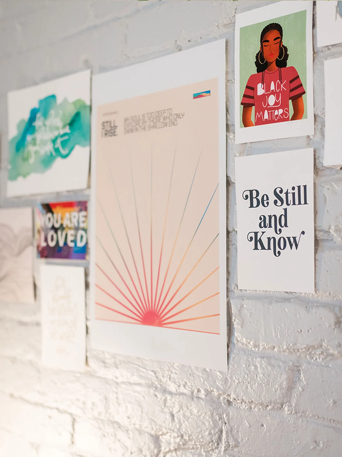 Art prints taped to the white brick wall in Dr. Lily Zehner's Denver office